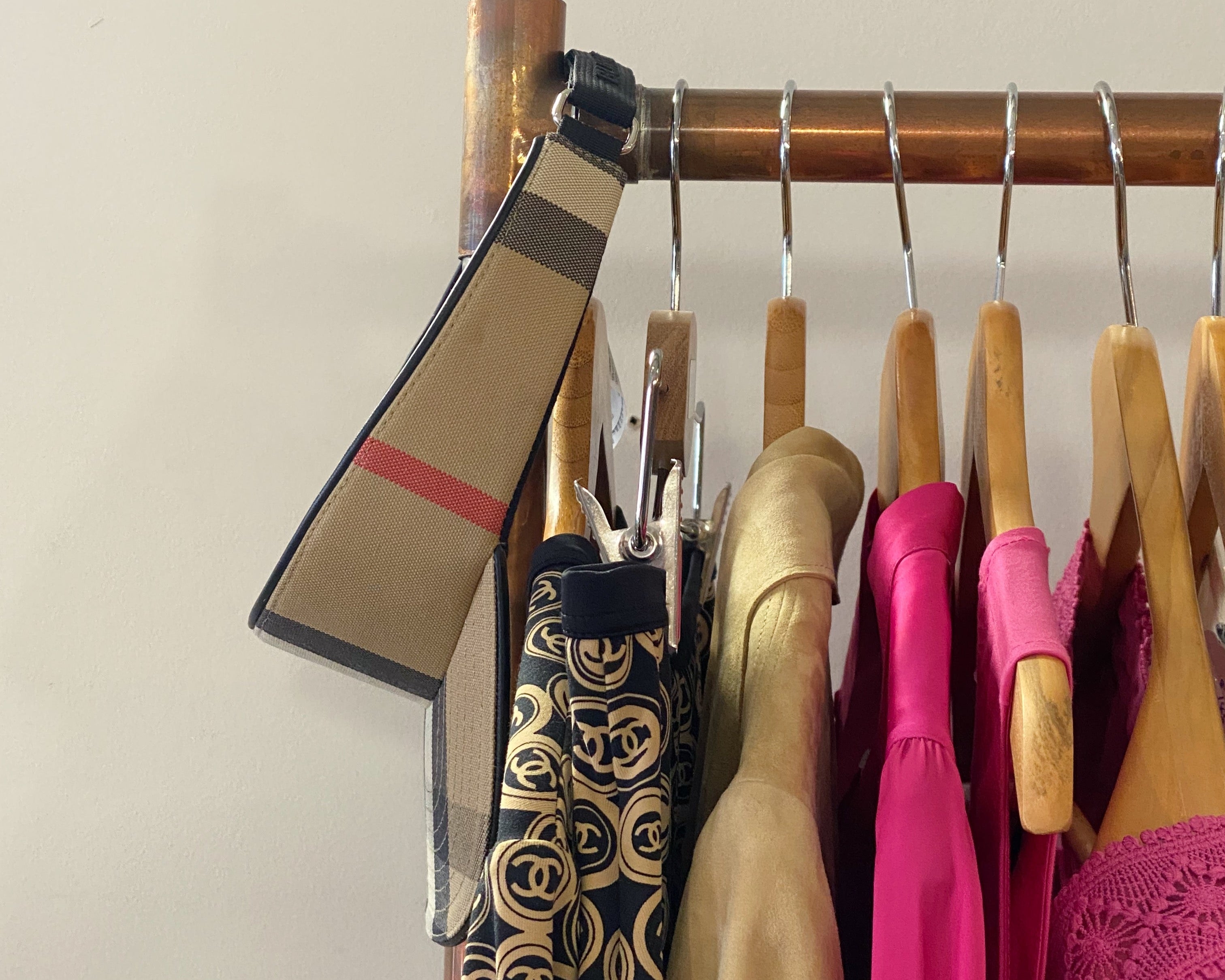 Clothing items on hangers with a visible brand tag against a plain background